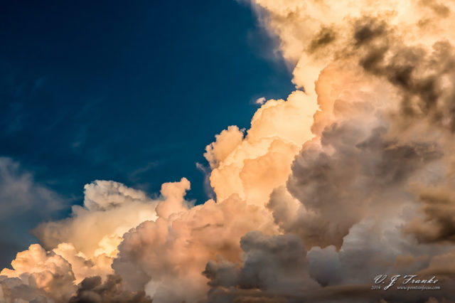 A building thunderstorm in the late afternoon light.